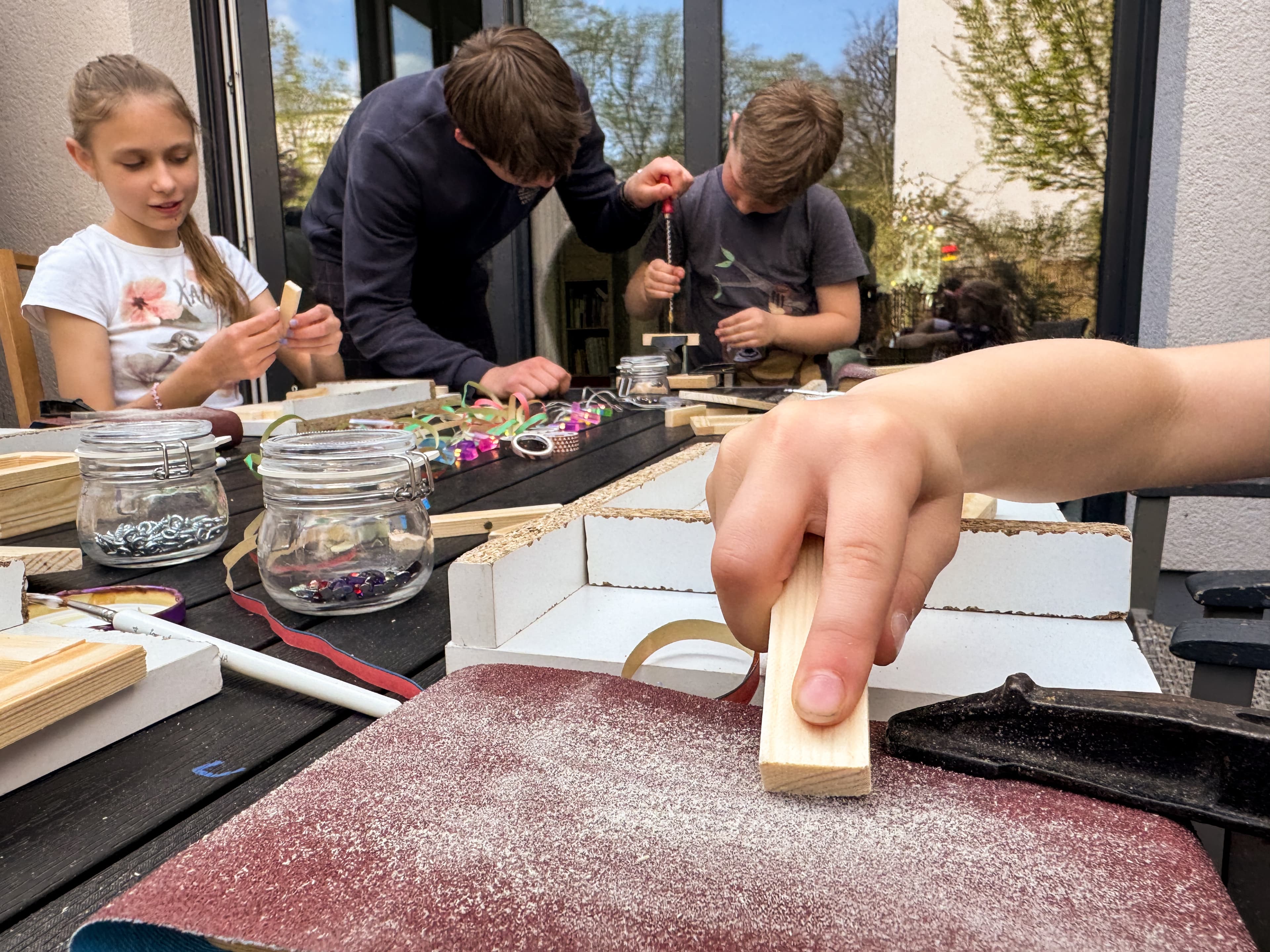 Kinder bauen gemeinsam an einem Tisch beim Kindergeburtstag
